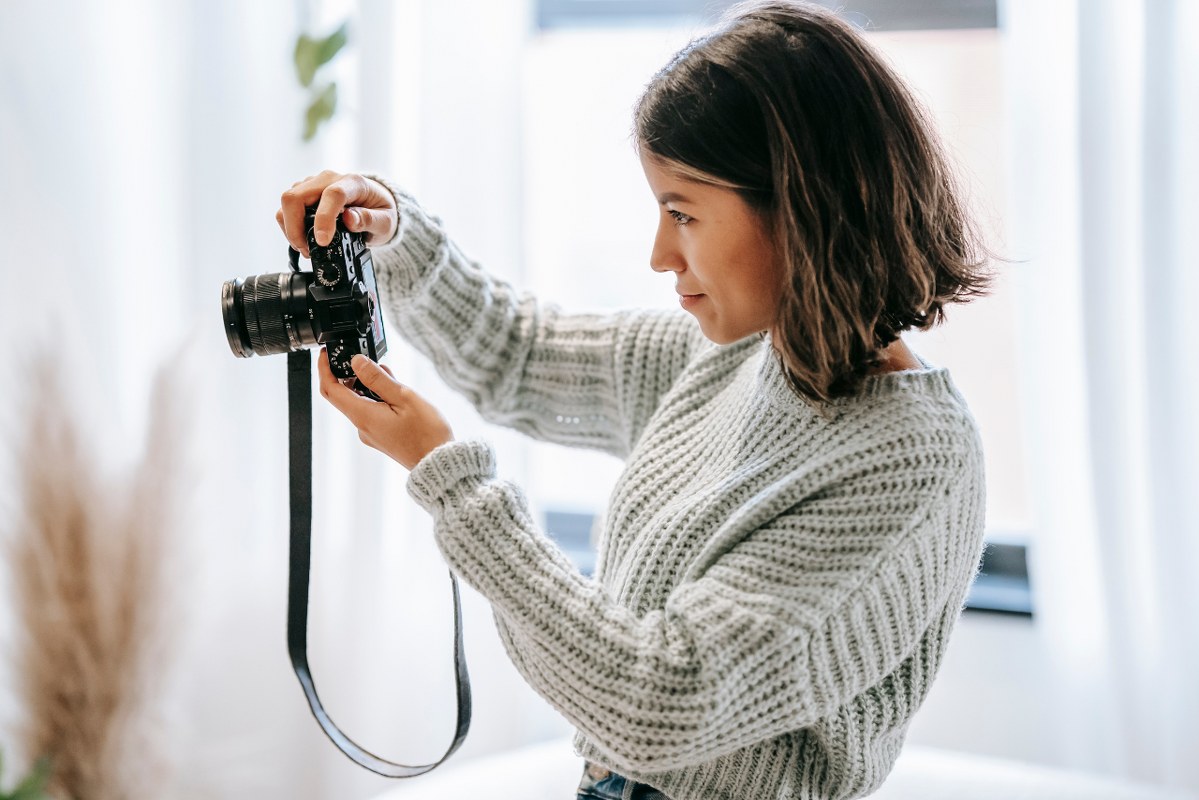 Photographer taking photo using dslr camera.