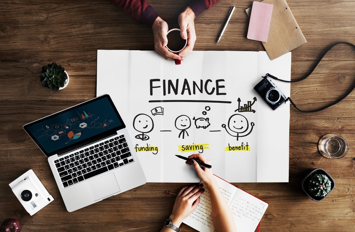 Poster about finances on wooden table.