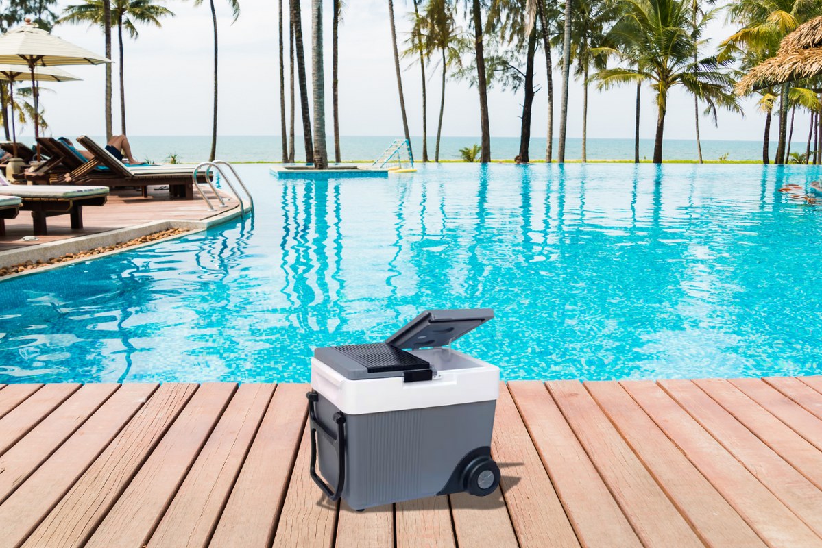 Rolling Electric Cooler with pool as background.