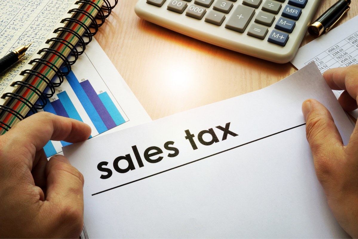 Sales tax permit held by hands.