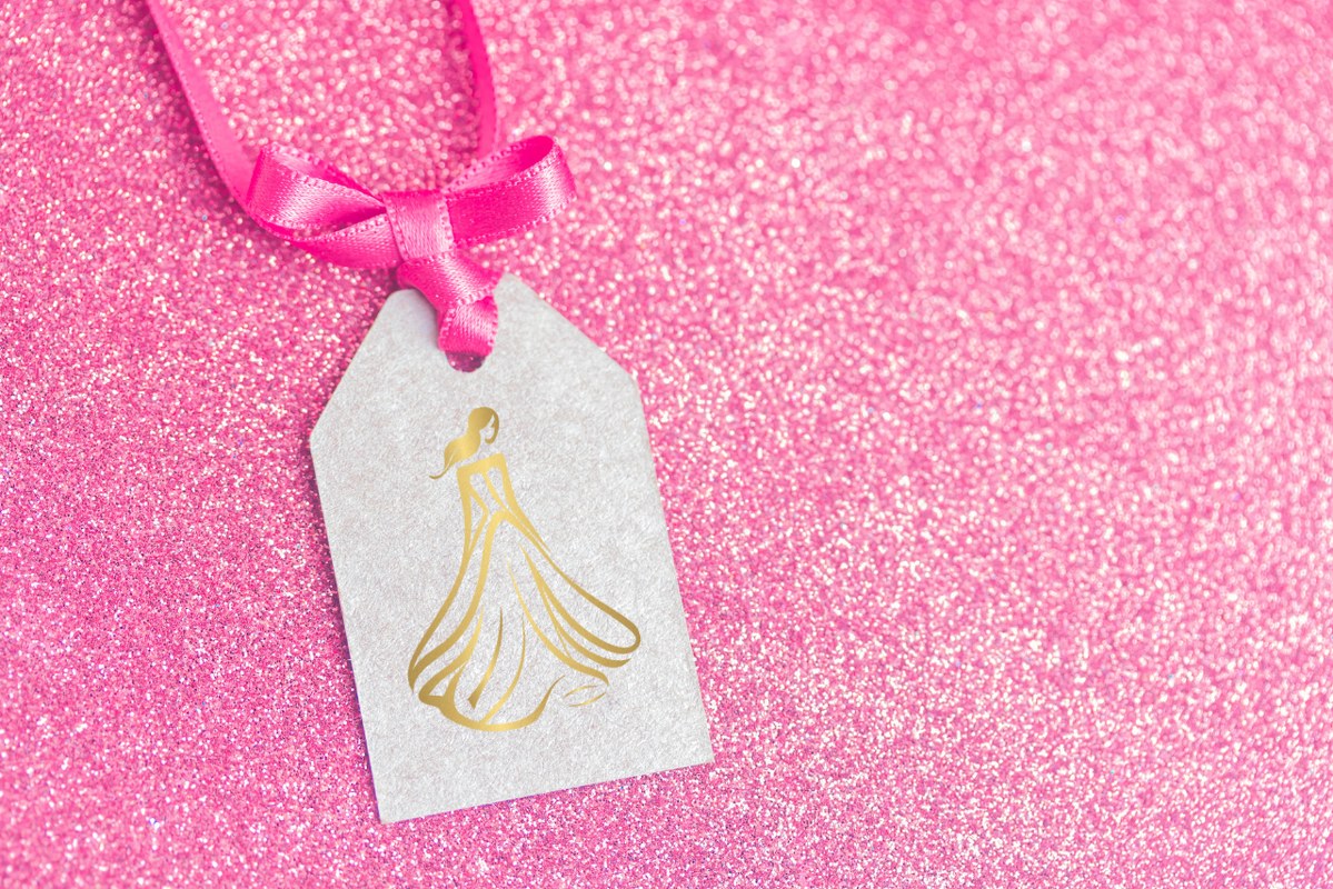 Sample designer logo on tag on pink background.