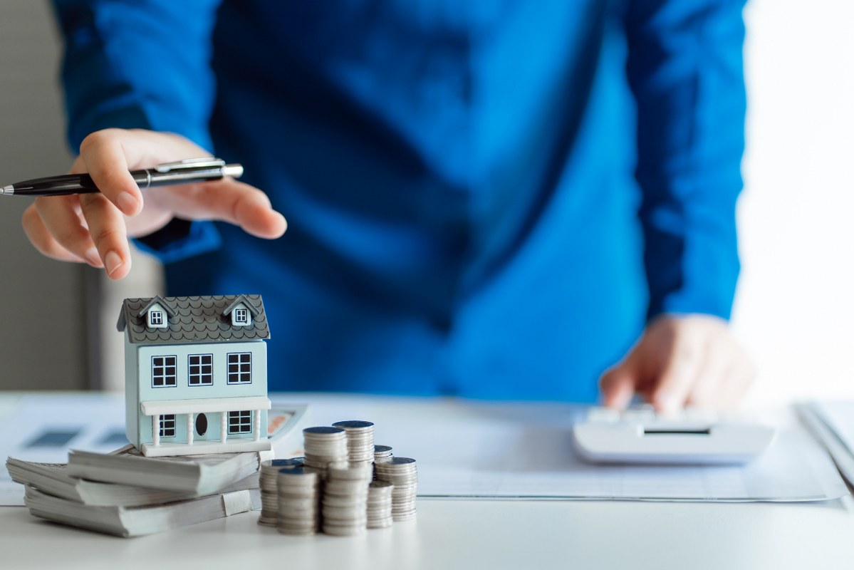 Saving Money for Real Estate Investment with Stack of Money.