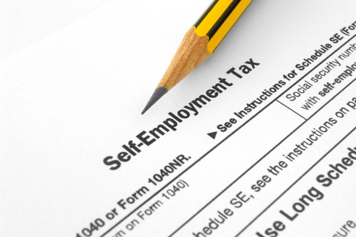 Self-Employment Tax close-up with pencil.