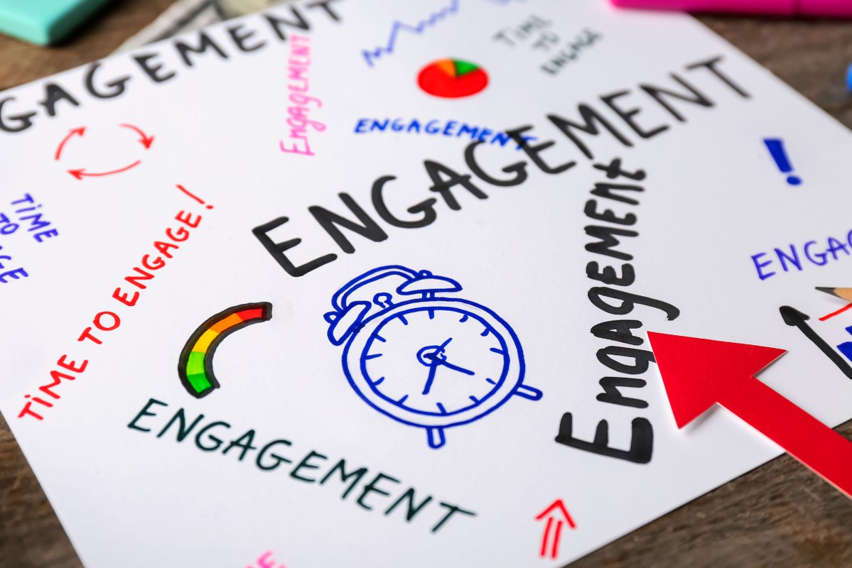 Sheet of Paper with Written Words ENGAGEMENT on Table.
