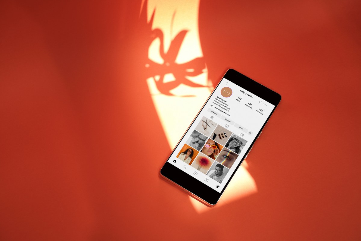 Social Media Mockup on Smartphone on Orange Background.