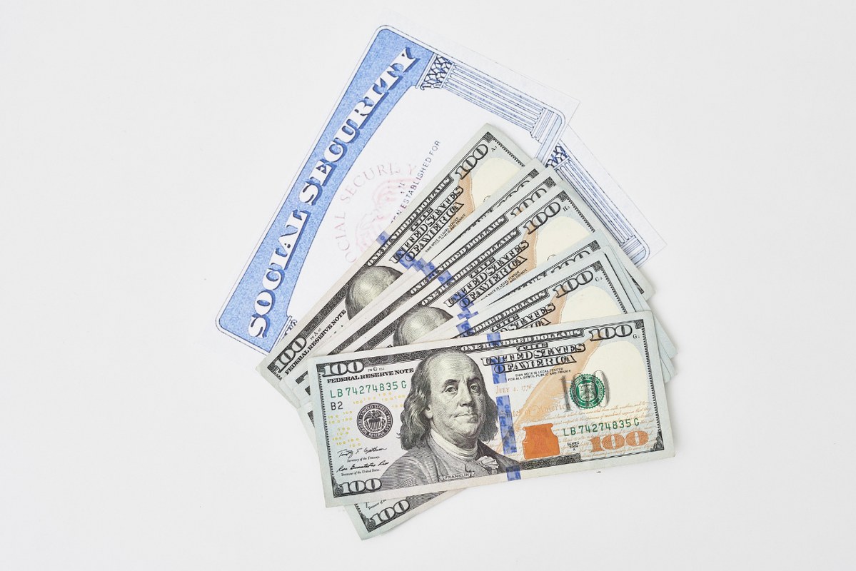 Social Security card and dollars.