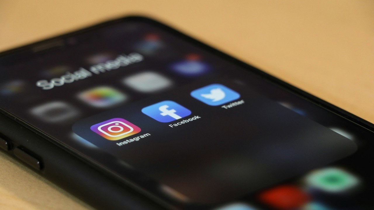 Social media app icons displayed on a phone.