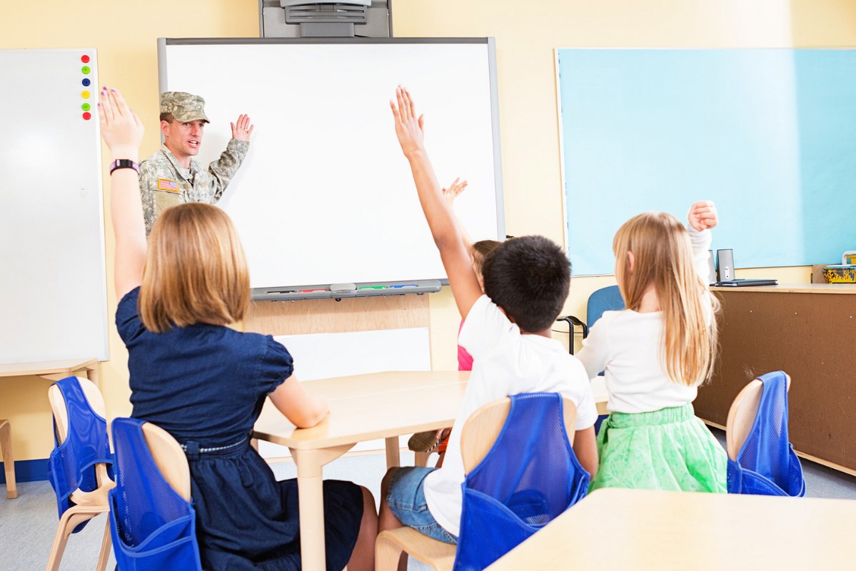 Soldier teaching children in classroom.