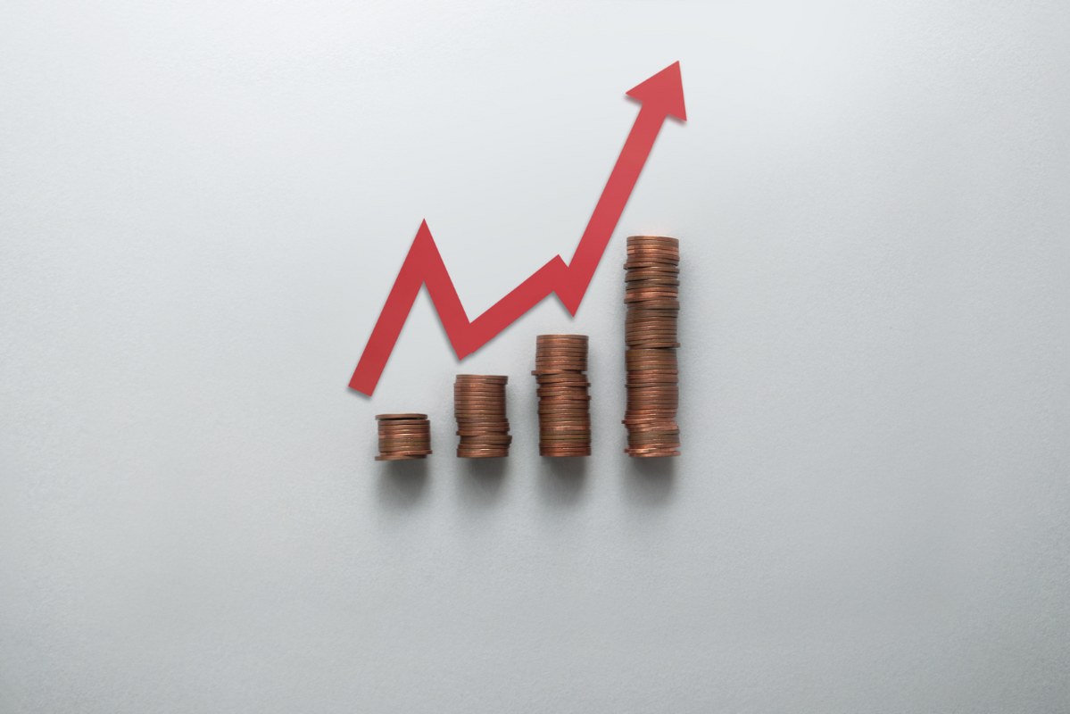 Stacks of coins with rising graph.