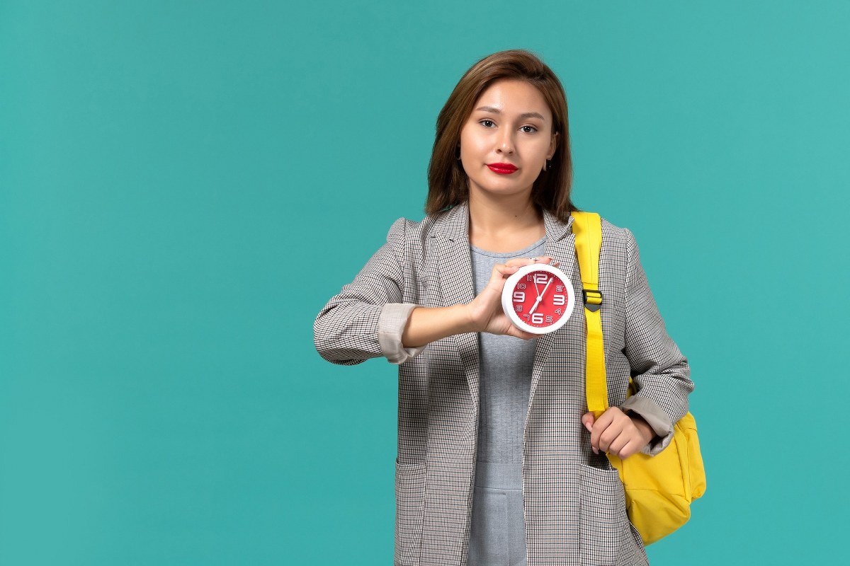 Student holding clocks.