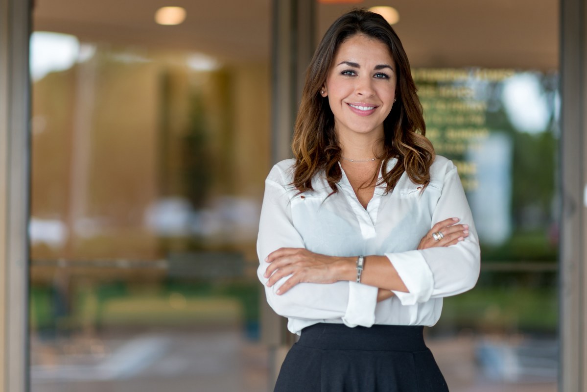 Successful woman small business owner smiling at camera.