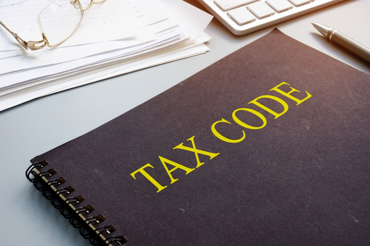 Tax code and financial documents in the office.