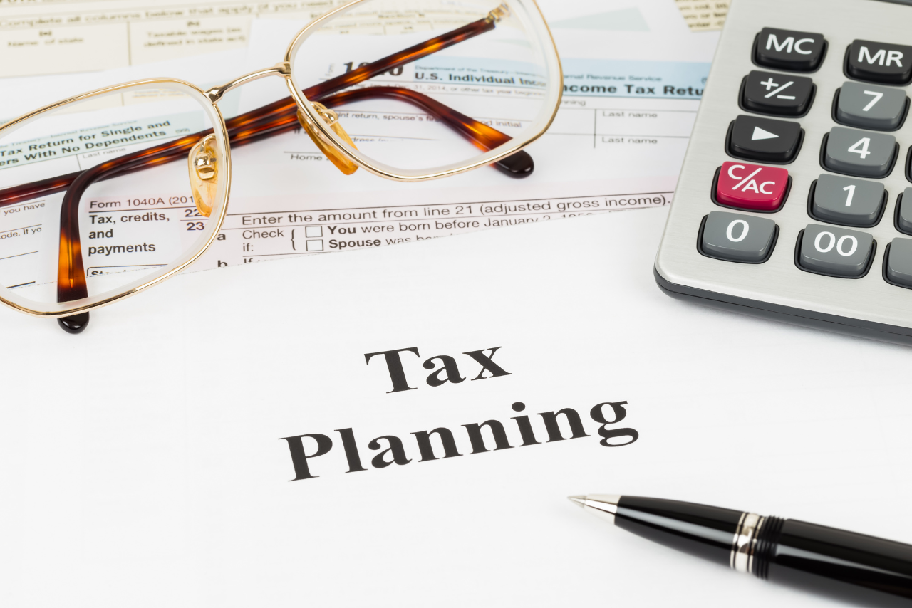 Tax planning wirh calculator and glasses taxation concept.
