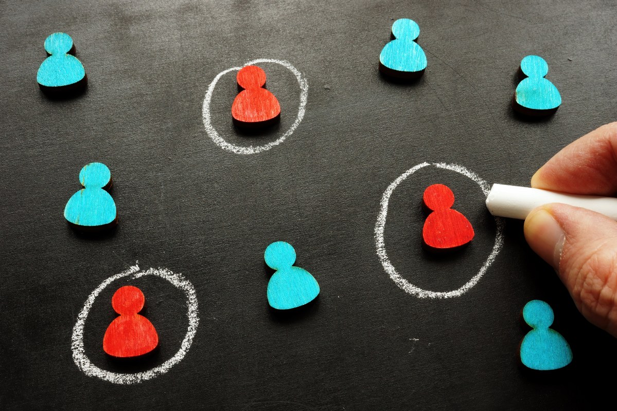 The hand is selecting and tracing the customer figures.