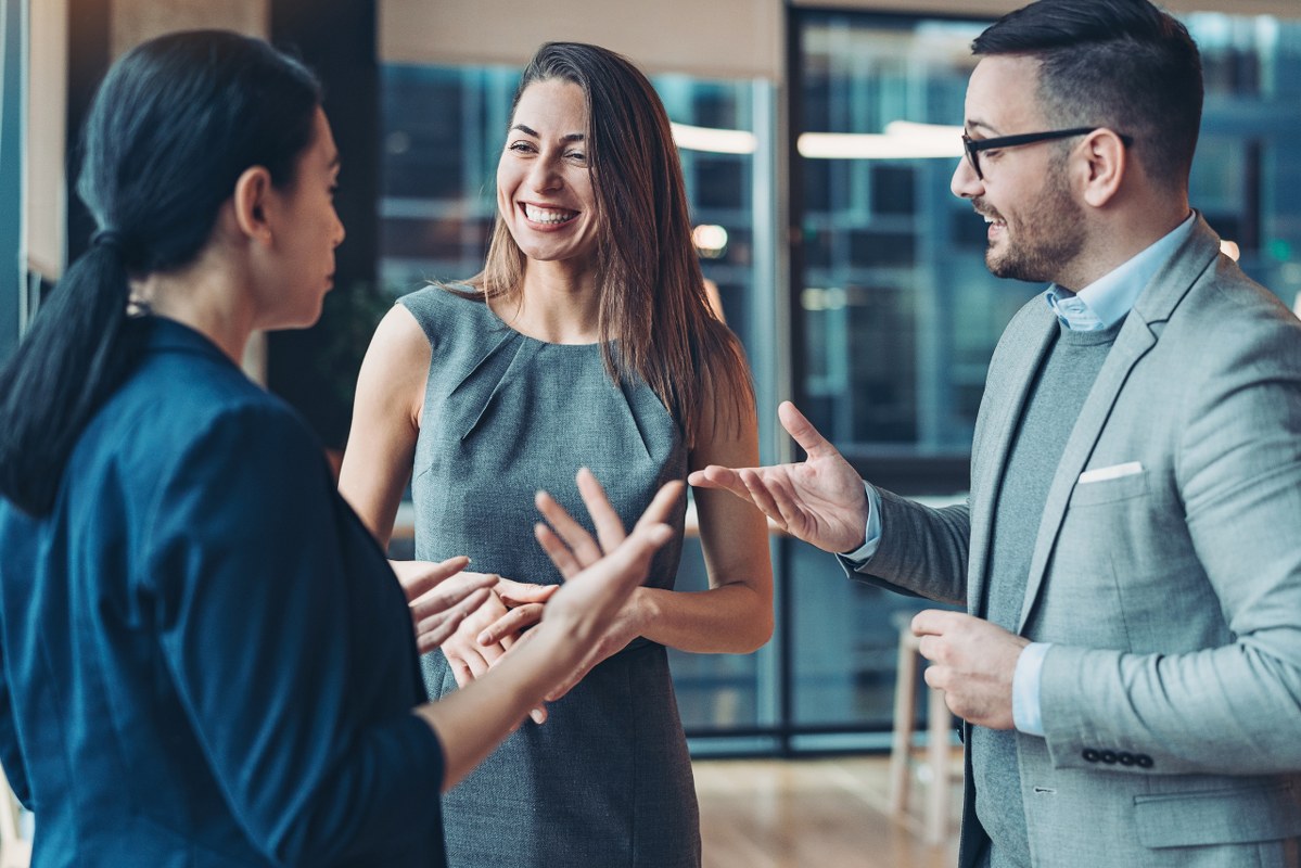 Three business people doing face-to-face networking.