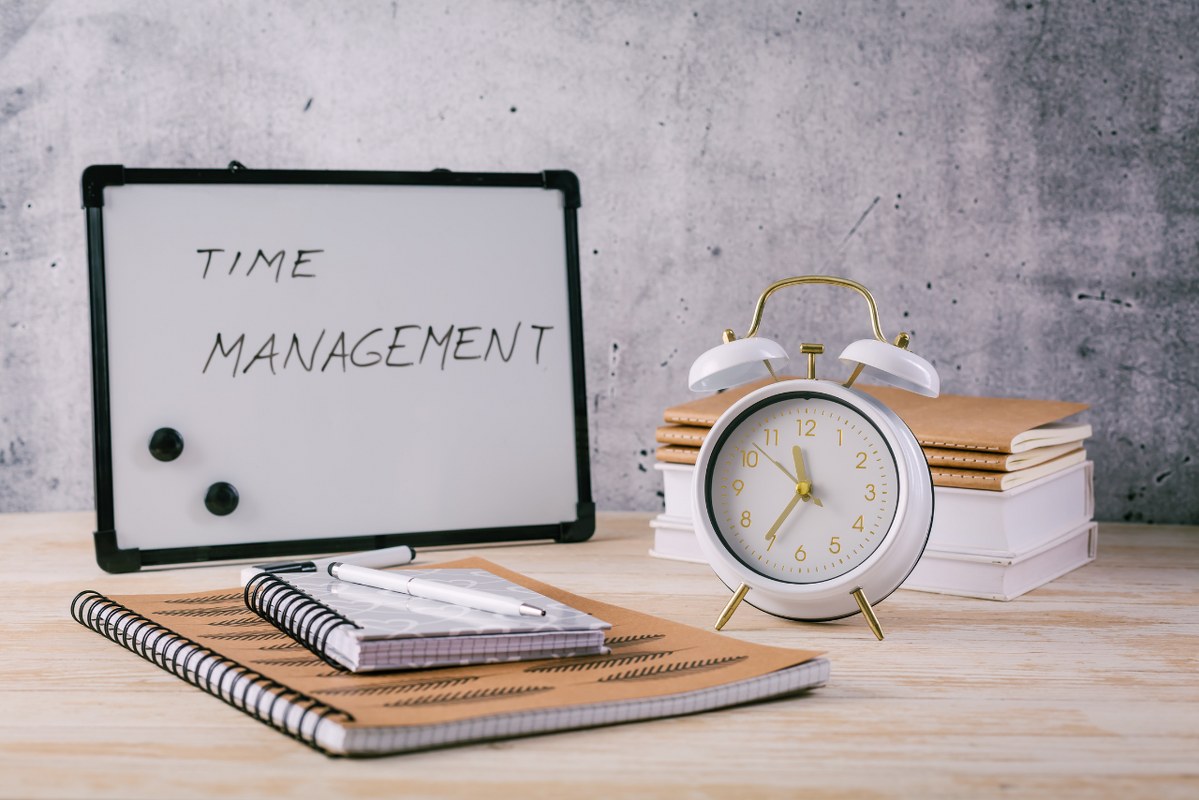 Time Management concept: Alarm Clock and Books.