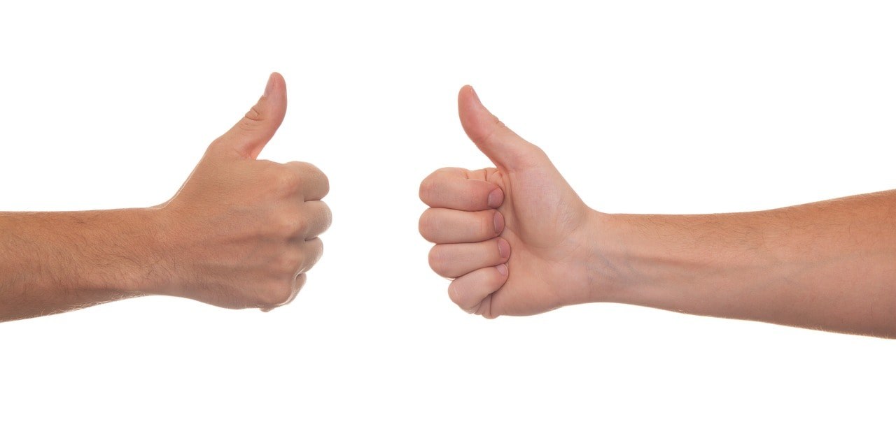 Two hands giving a thumbs up approval.