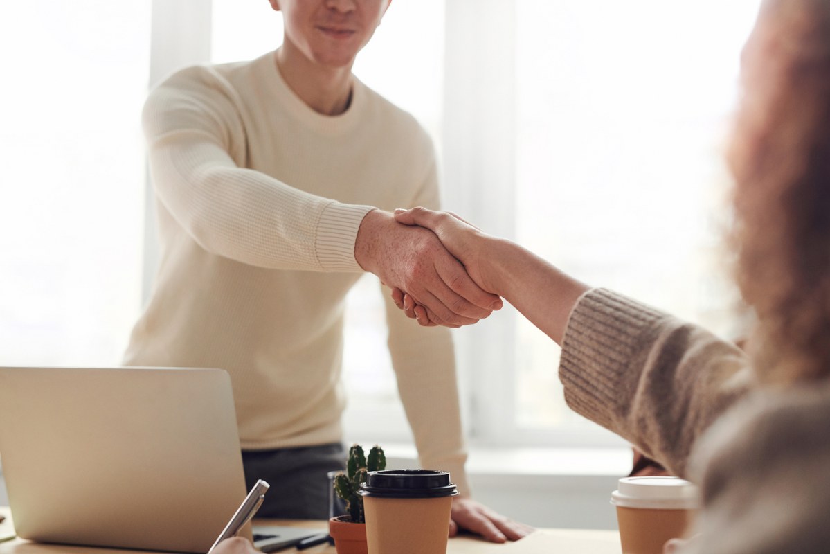 Two people shake hands after negotiation.