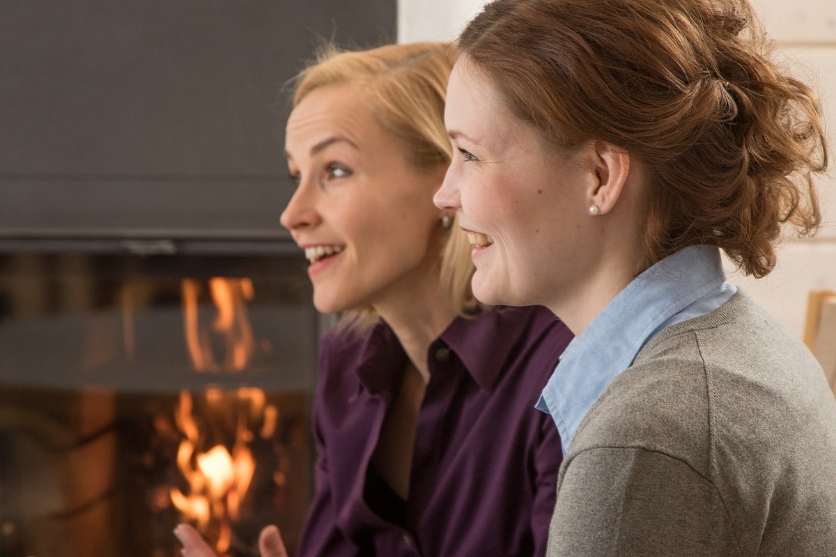 Two women talking to a client.