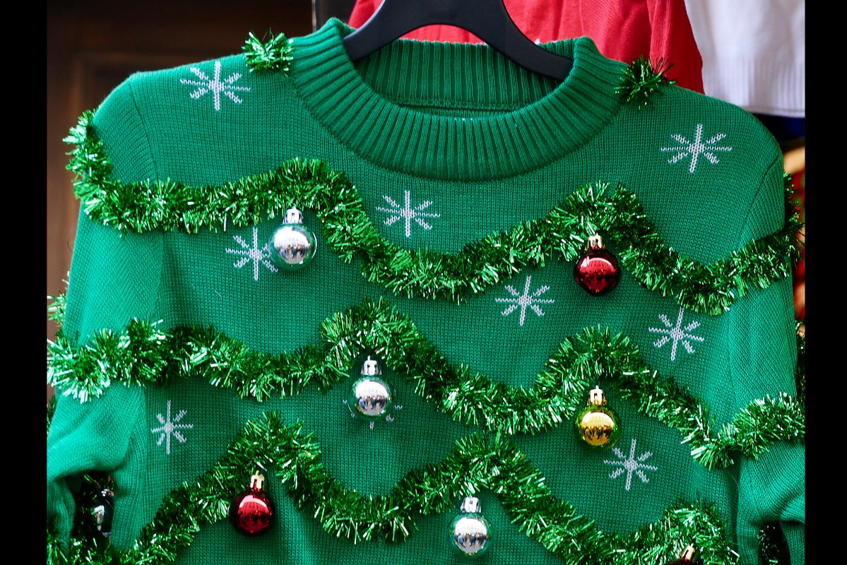 Ugly green Christmas sweater with decor balls.