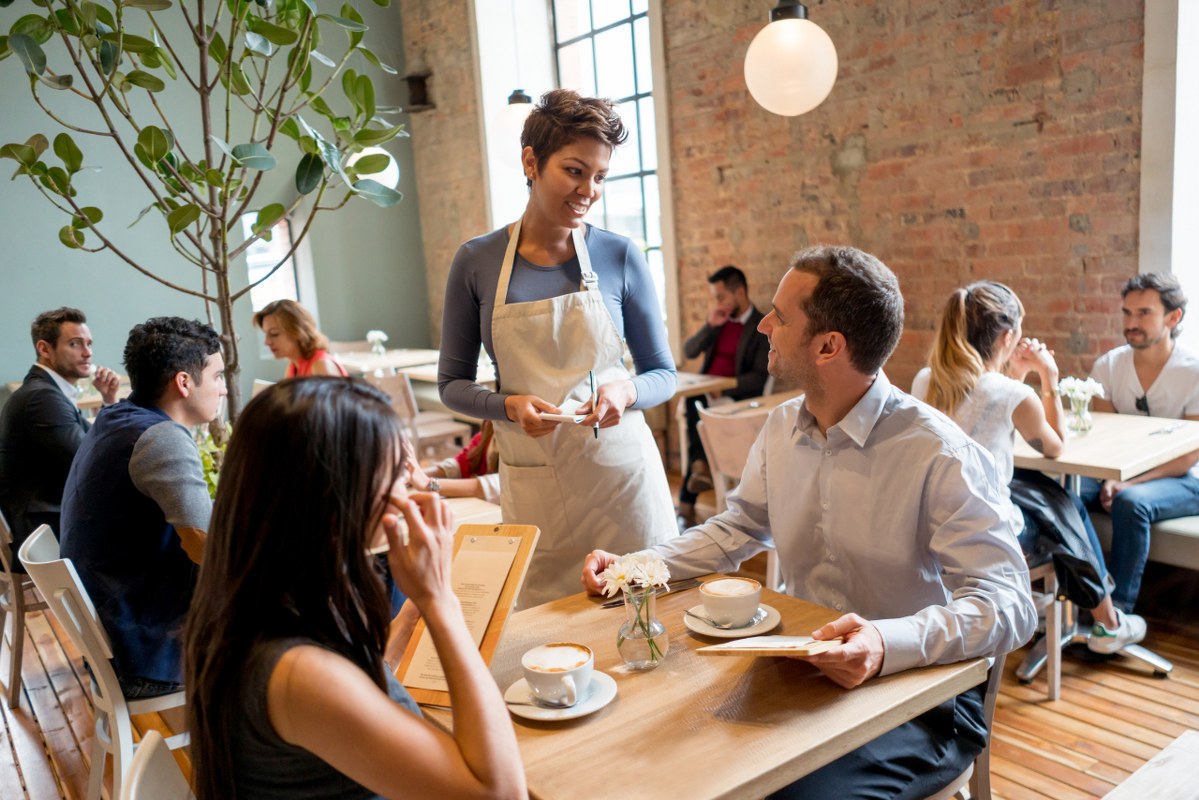 Waitress serving people at a restaurant.