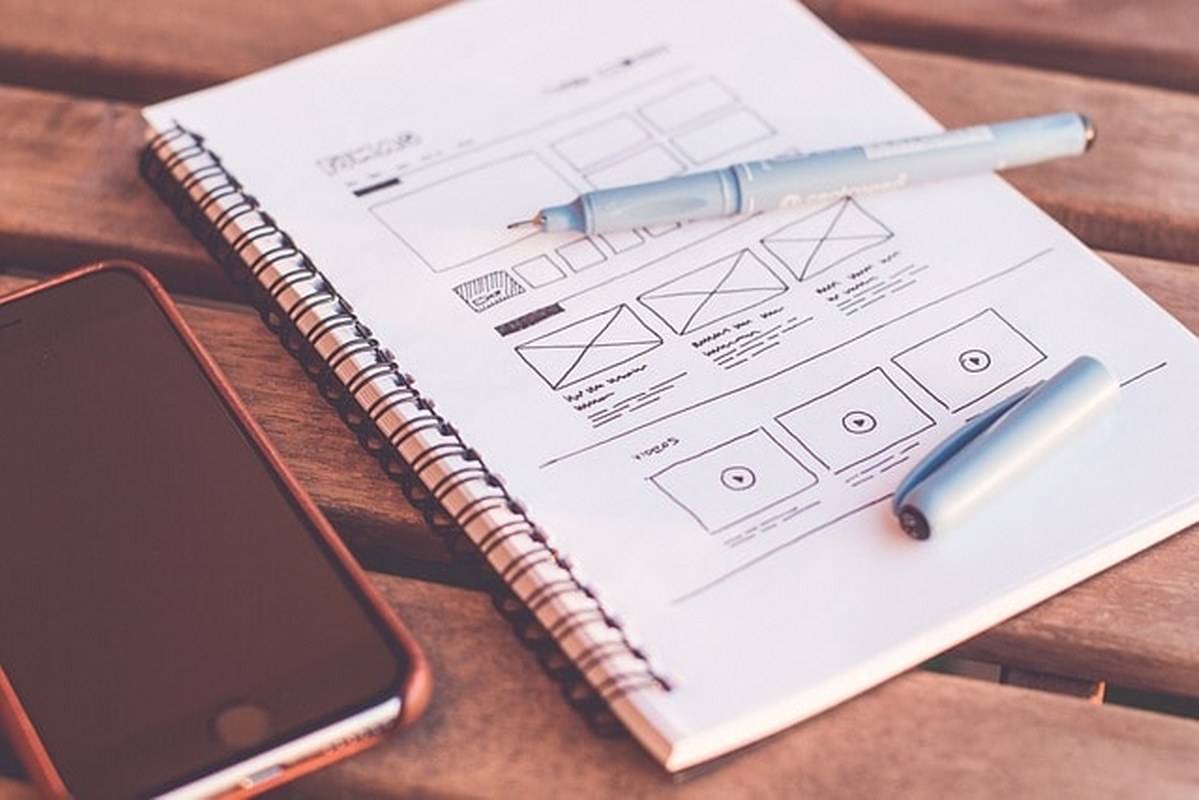 Website design sketch in a notepad.