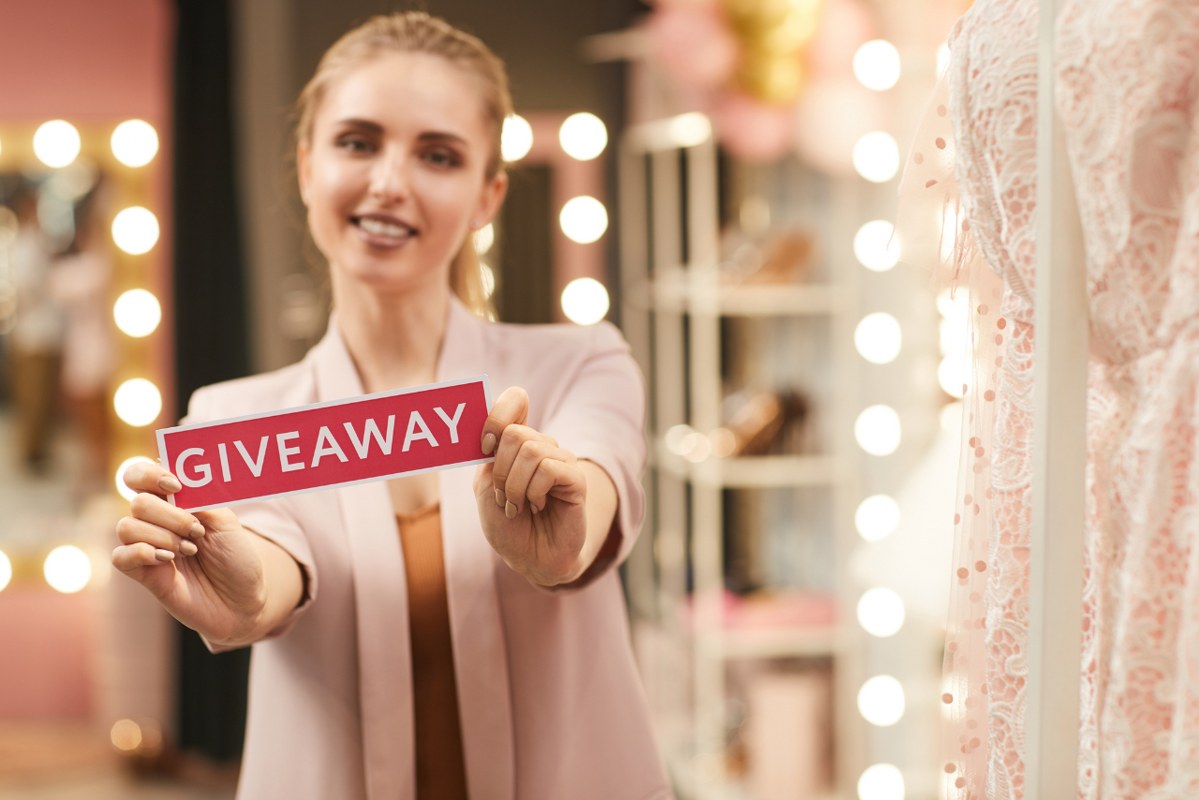 Woman Holding Giveaway Sign.