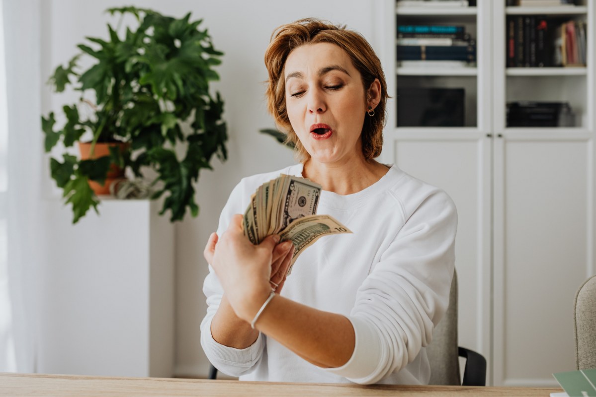 Woman Holding Lots of Money.