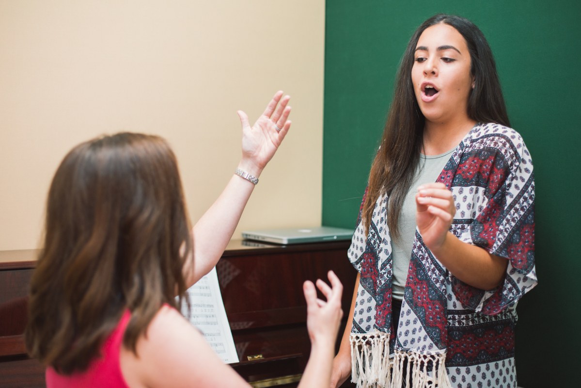 Woman giving singing lessons.