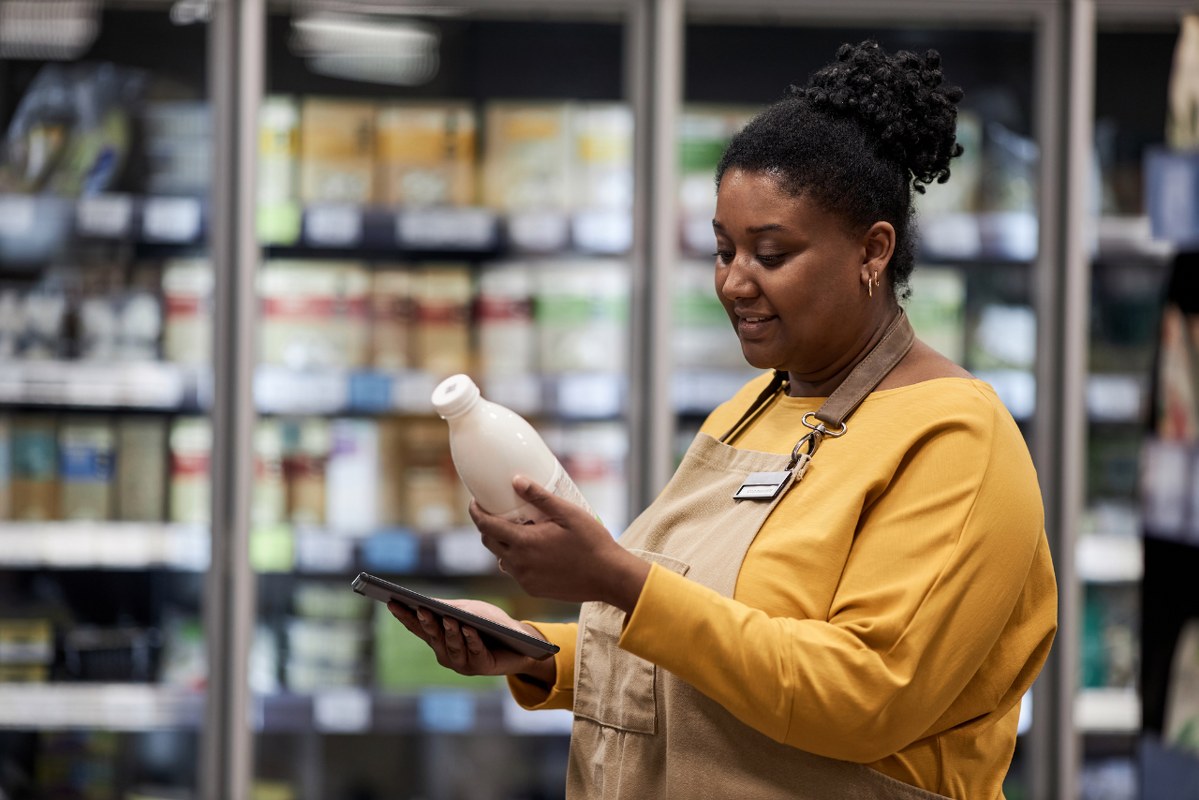 Woman looking at drinks' expiration date.