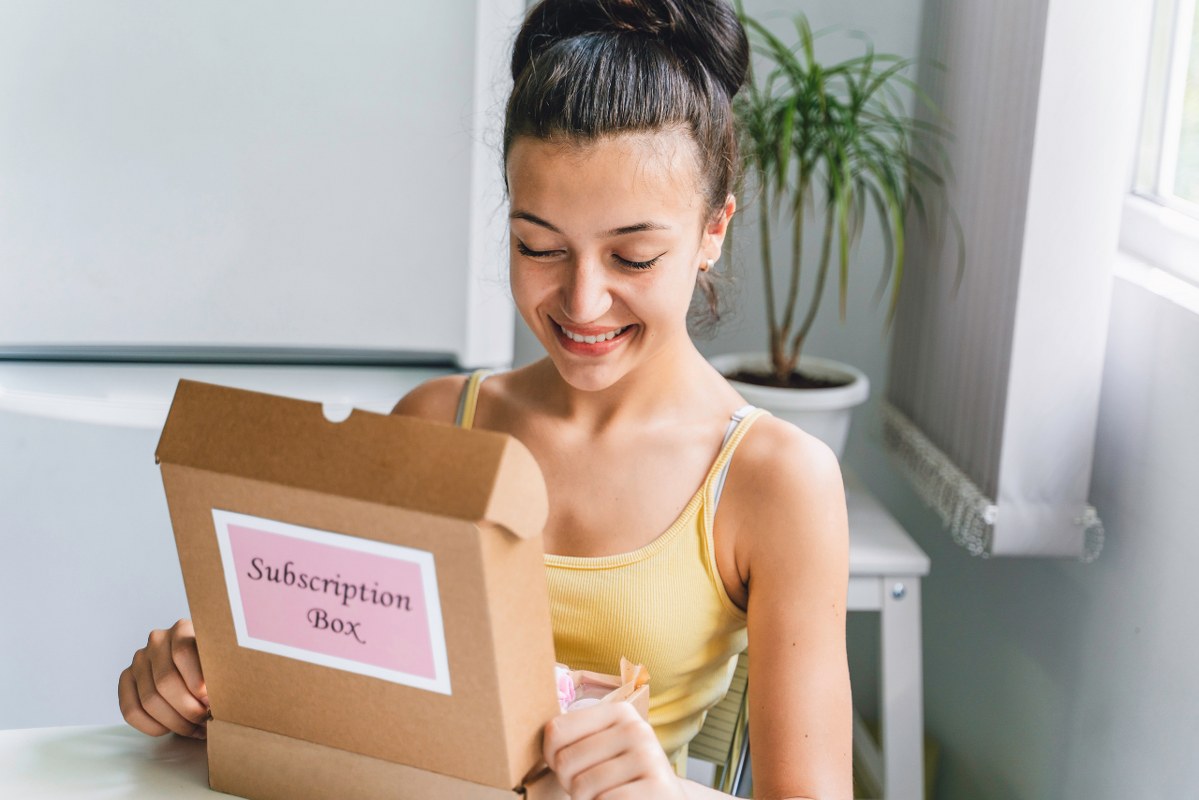 Woman opens vegan subscription box.