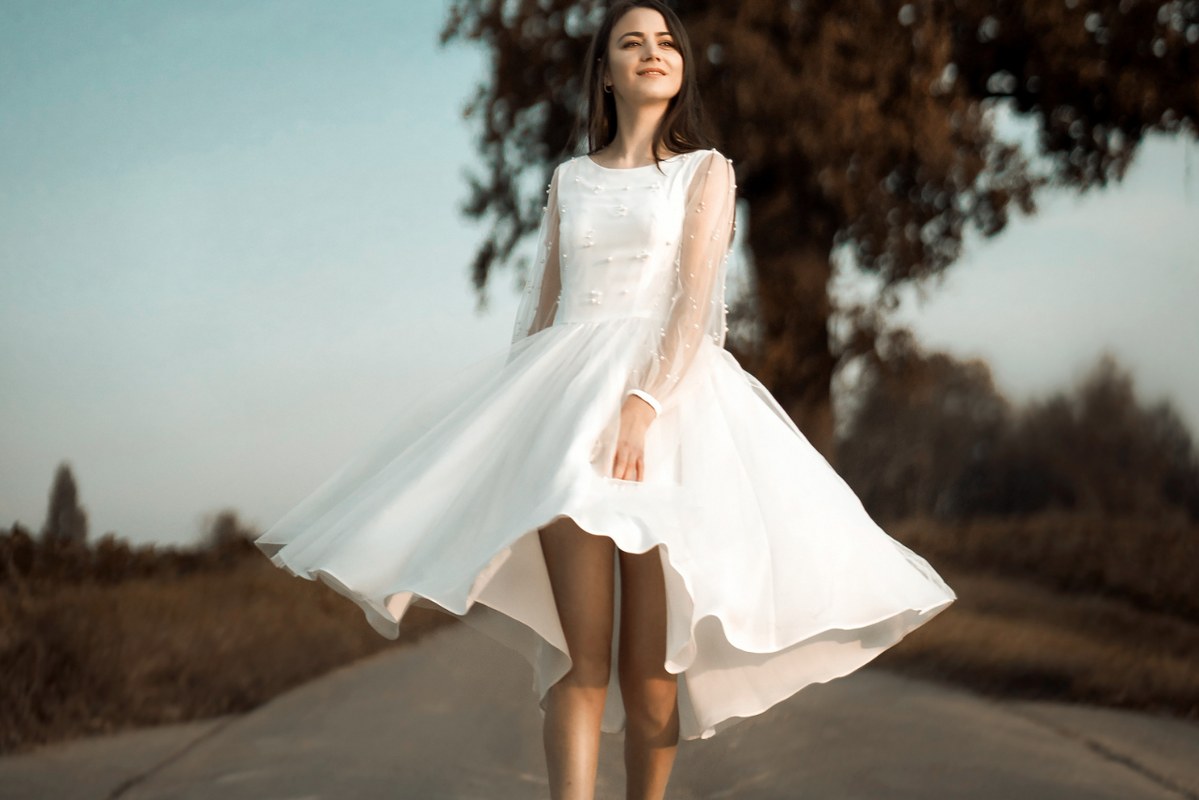 Woman wearing white cocktail dress.