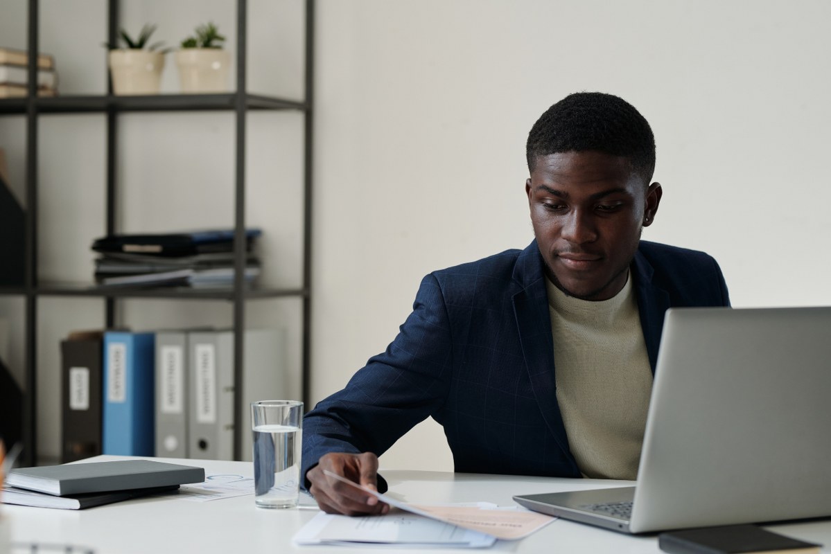 Young confident African American CEO working on desk.