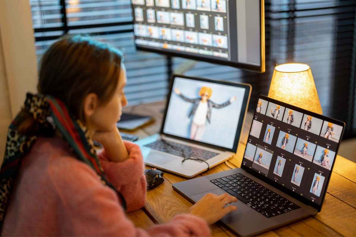 Young lady Photographer Editing Photos at Home Office.