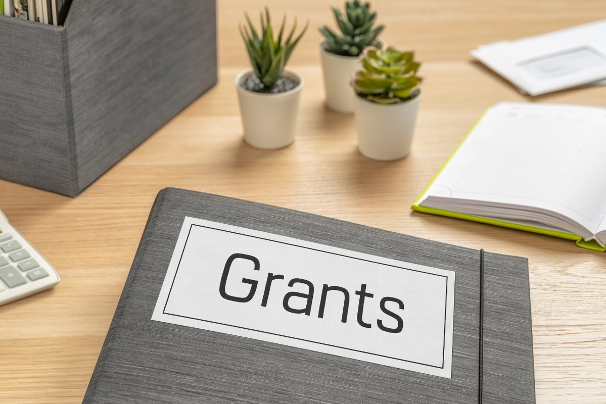 A Folder on a Desk with the Label Grants.