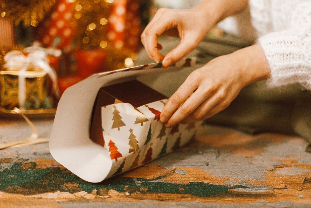 A Person Wrapping a Gift.