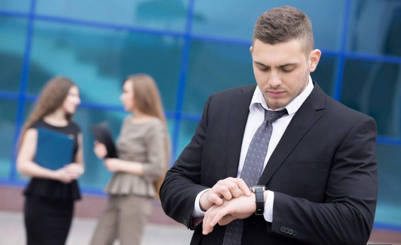A businessman looking at his watch.