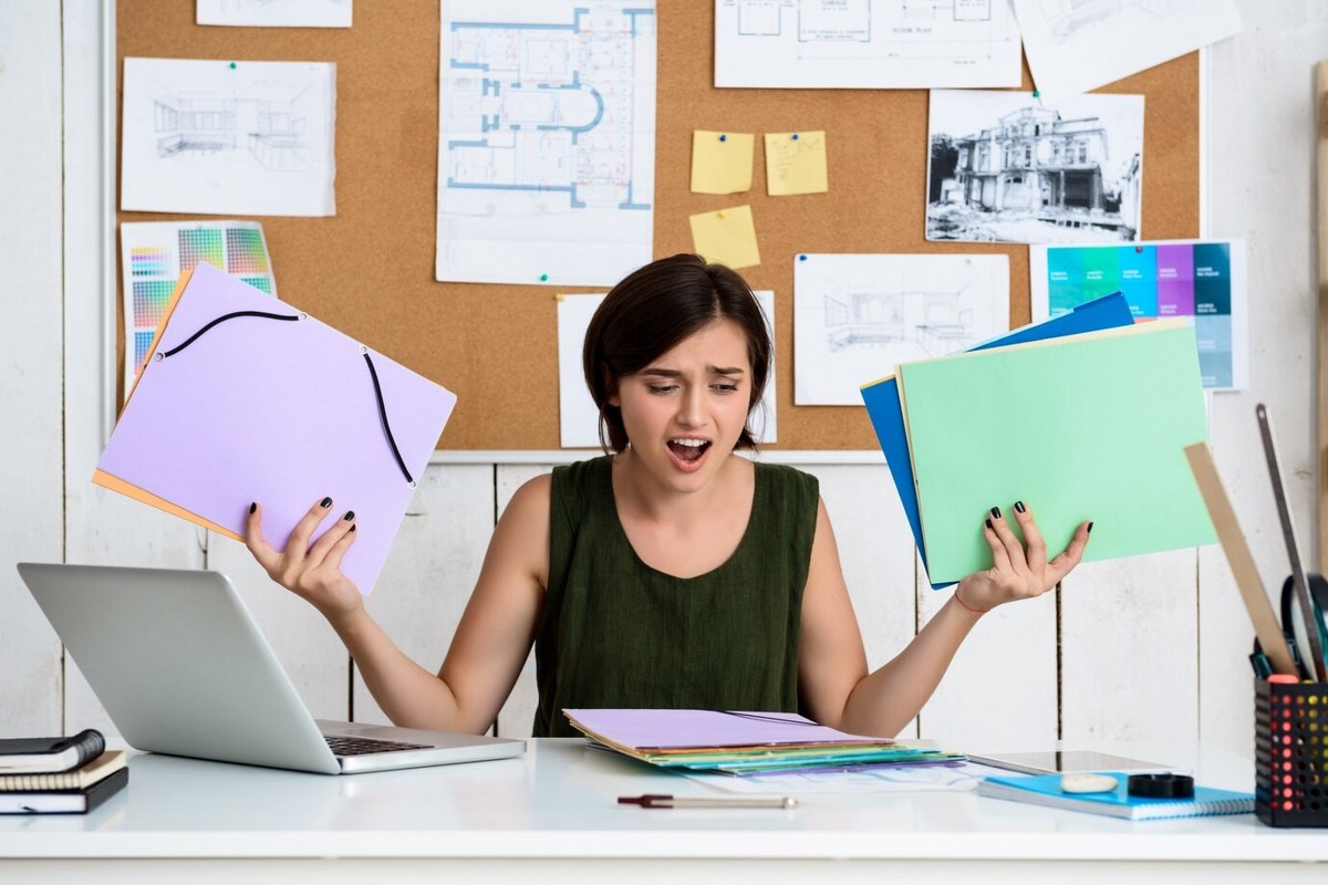 A confused woman is holding a file in her hand.