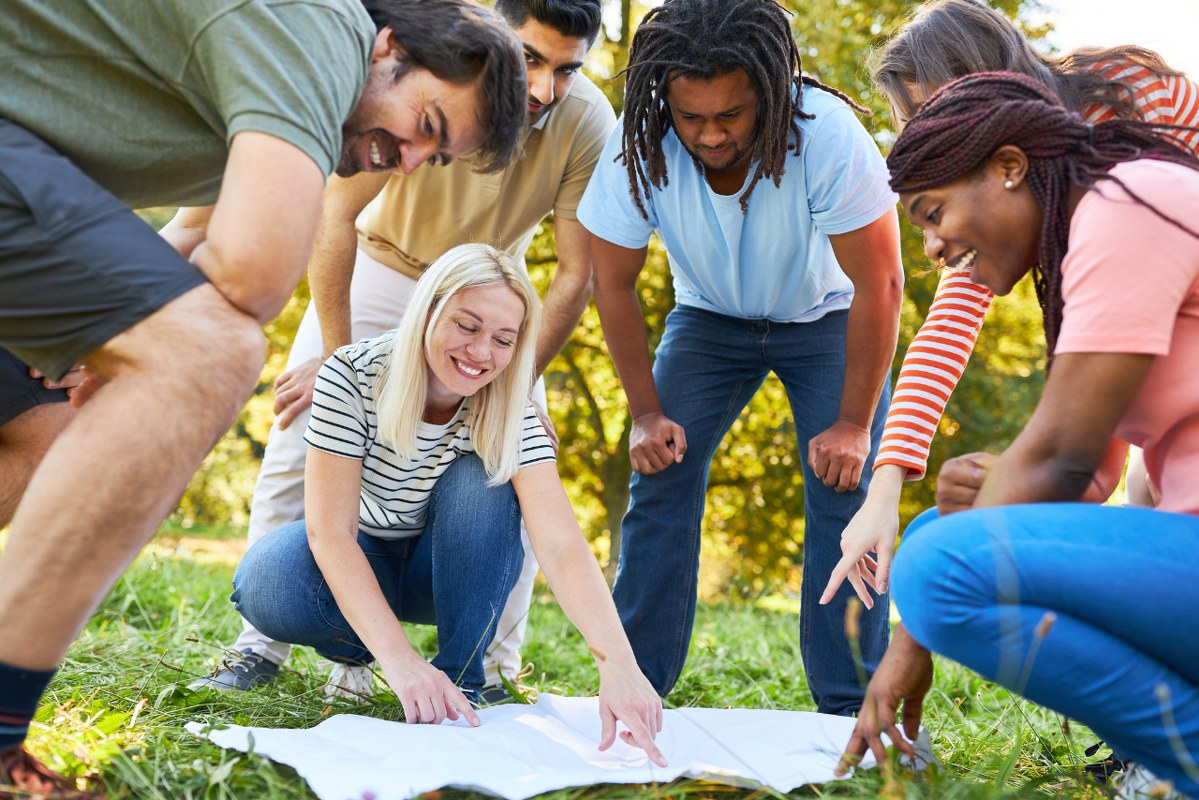 A group of People Looking at Map during Treasure Hunt.
