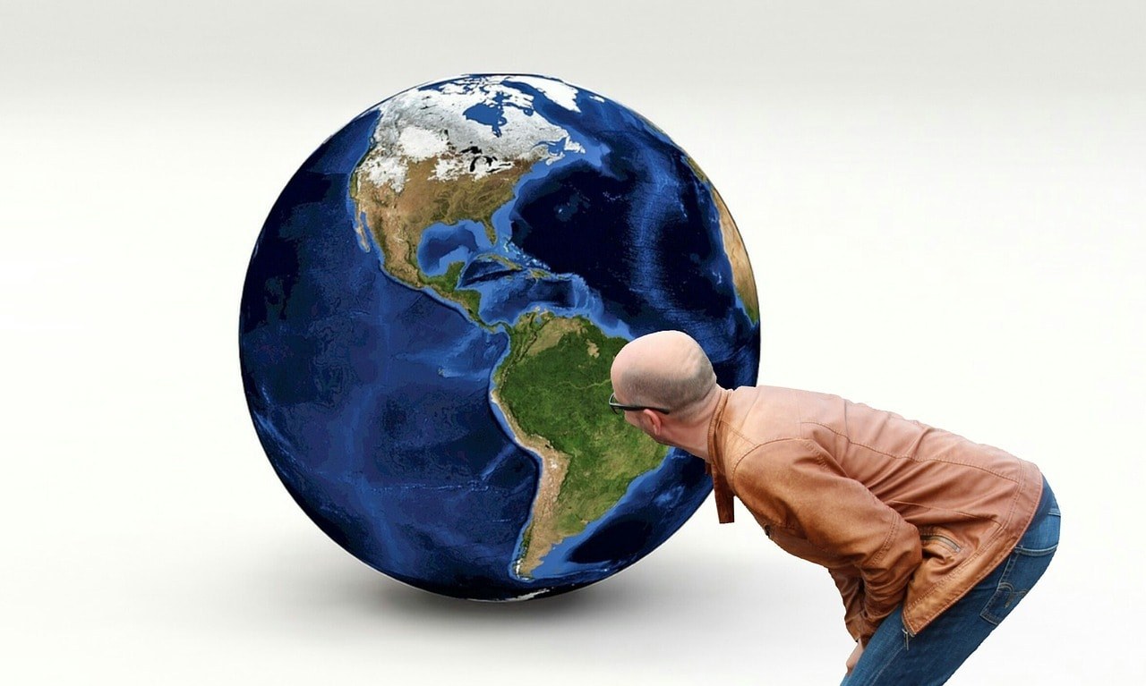 A man looking at the globe.