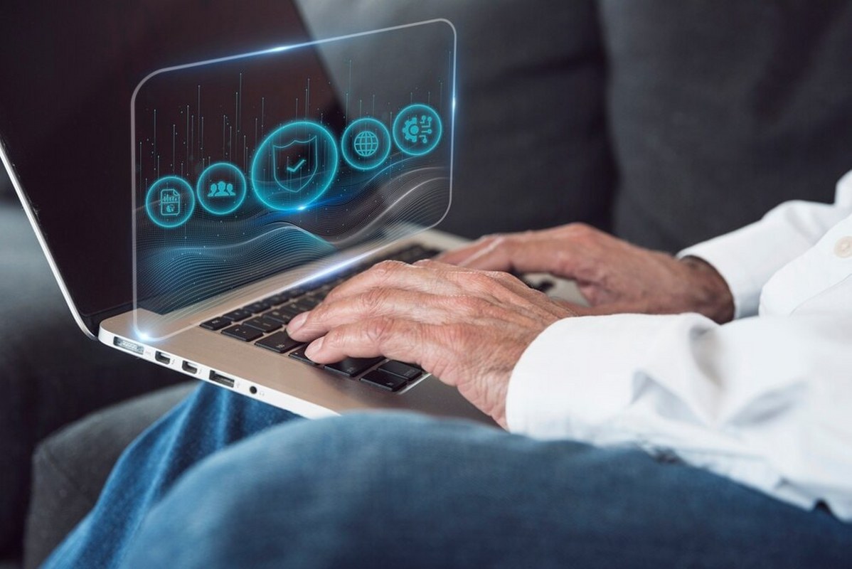 A man using a laptop showing a security concept.