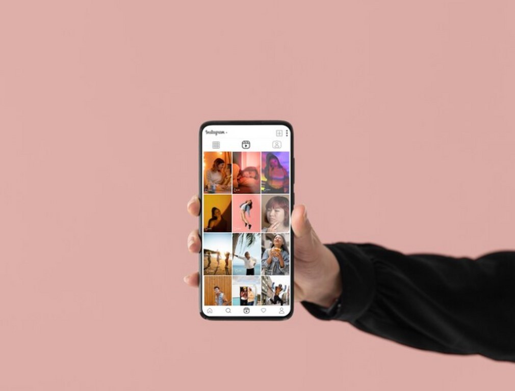 A person holding a phone showing pictures on Instagram. 