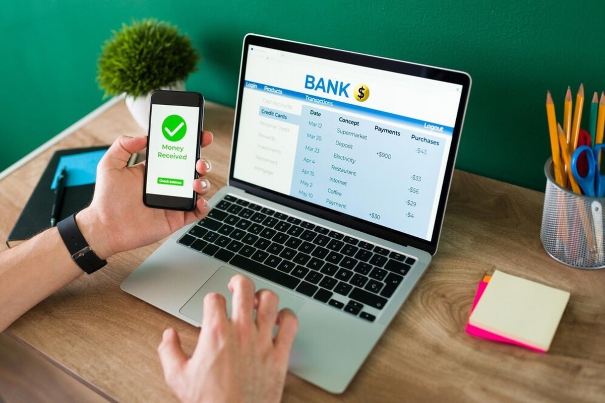 A person using his gadgets to do a banking transaction.