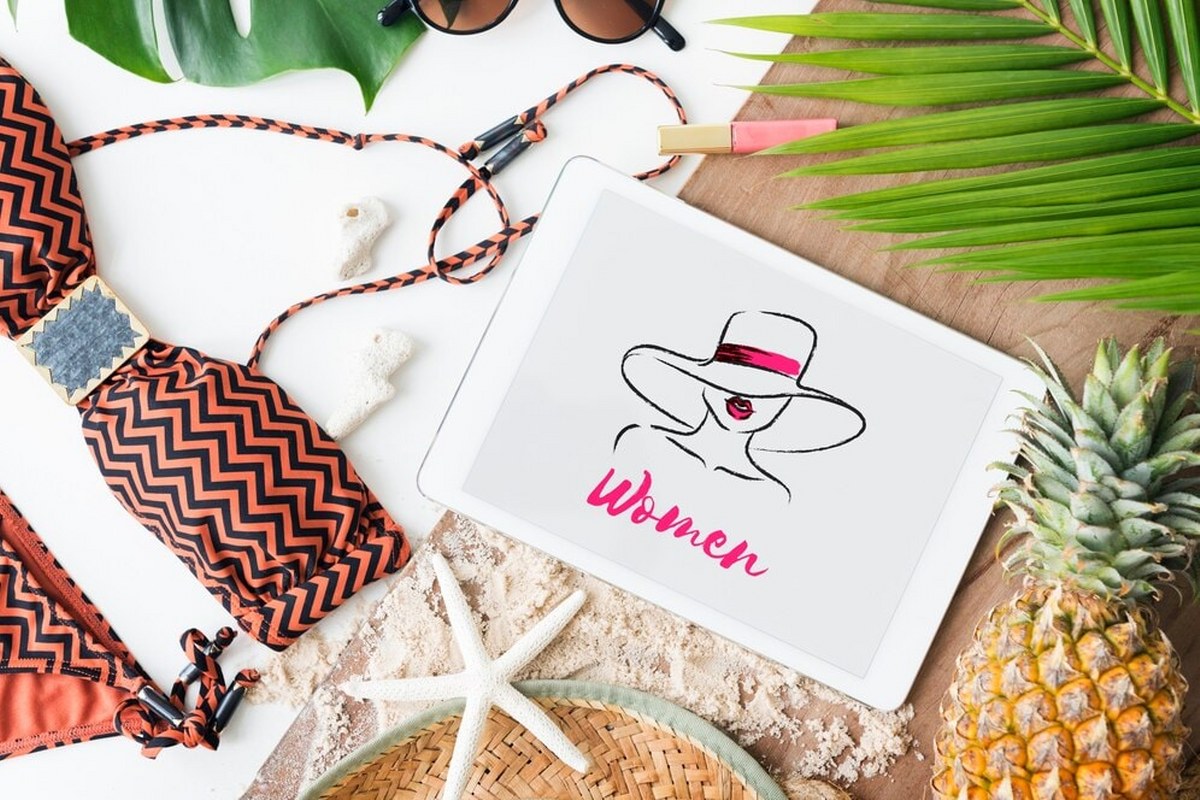 A tablet shows an image of a swimwear logo and its name.