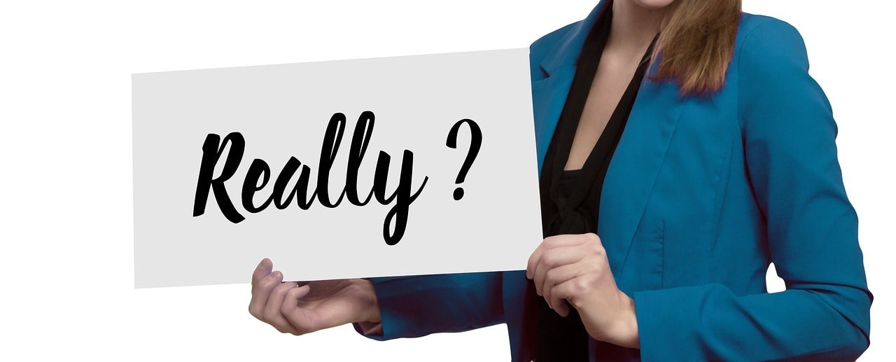 A woman holding a card written 