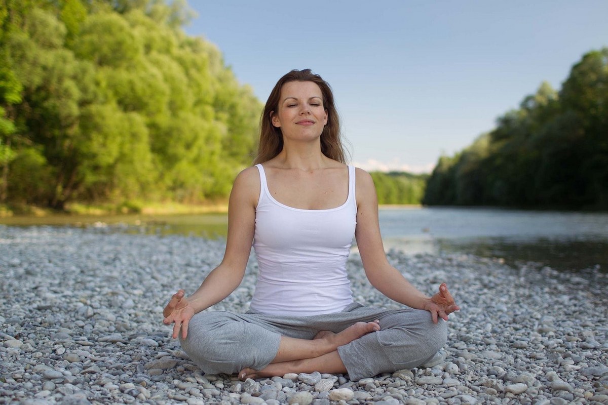 A woman meditating.