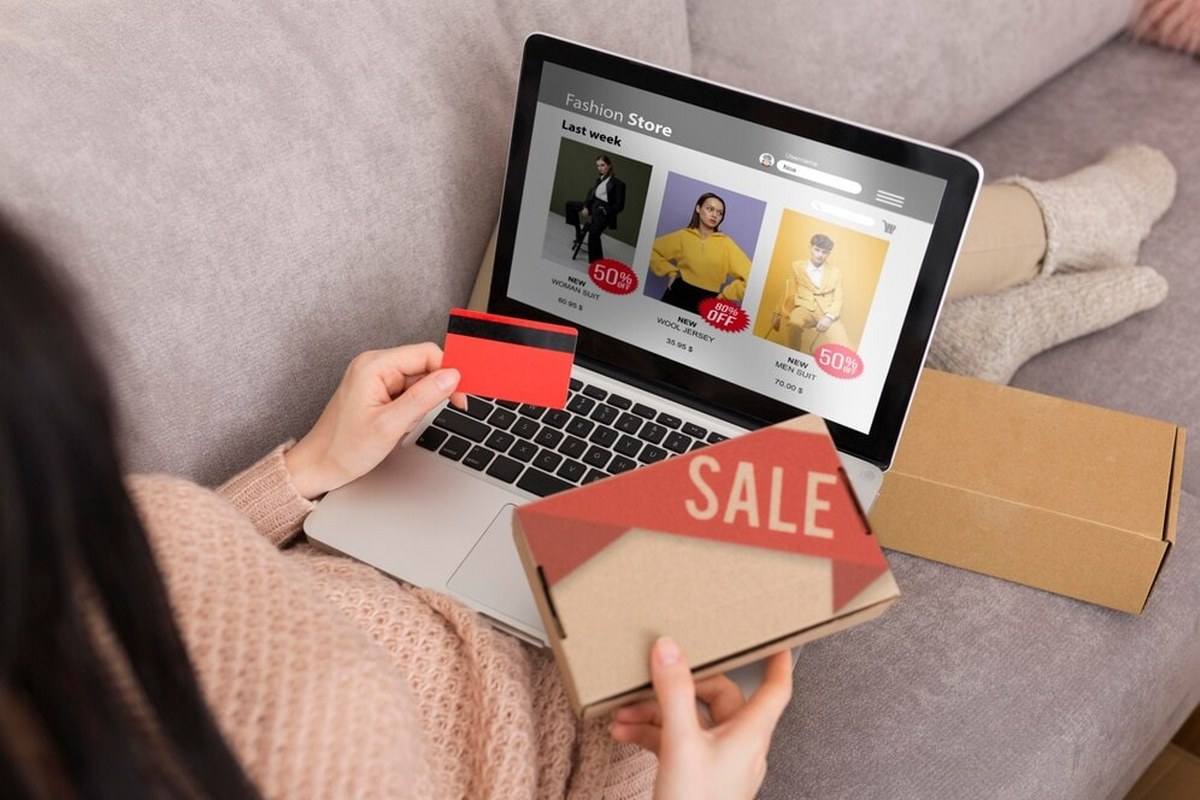 A woman uses a laptop for online shopping.