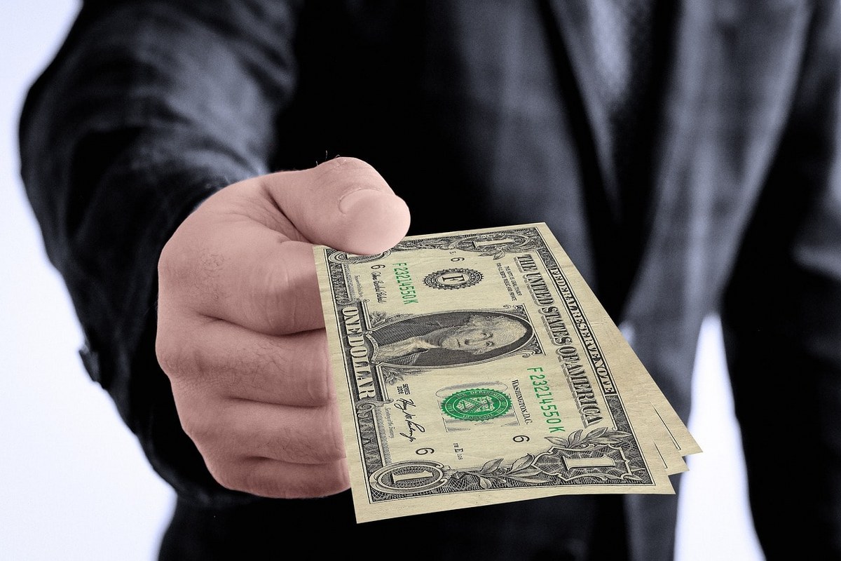 An employee holding money.
