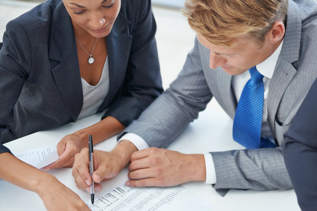 Business people discussing cash flow forecast.