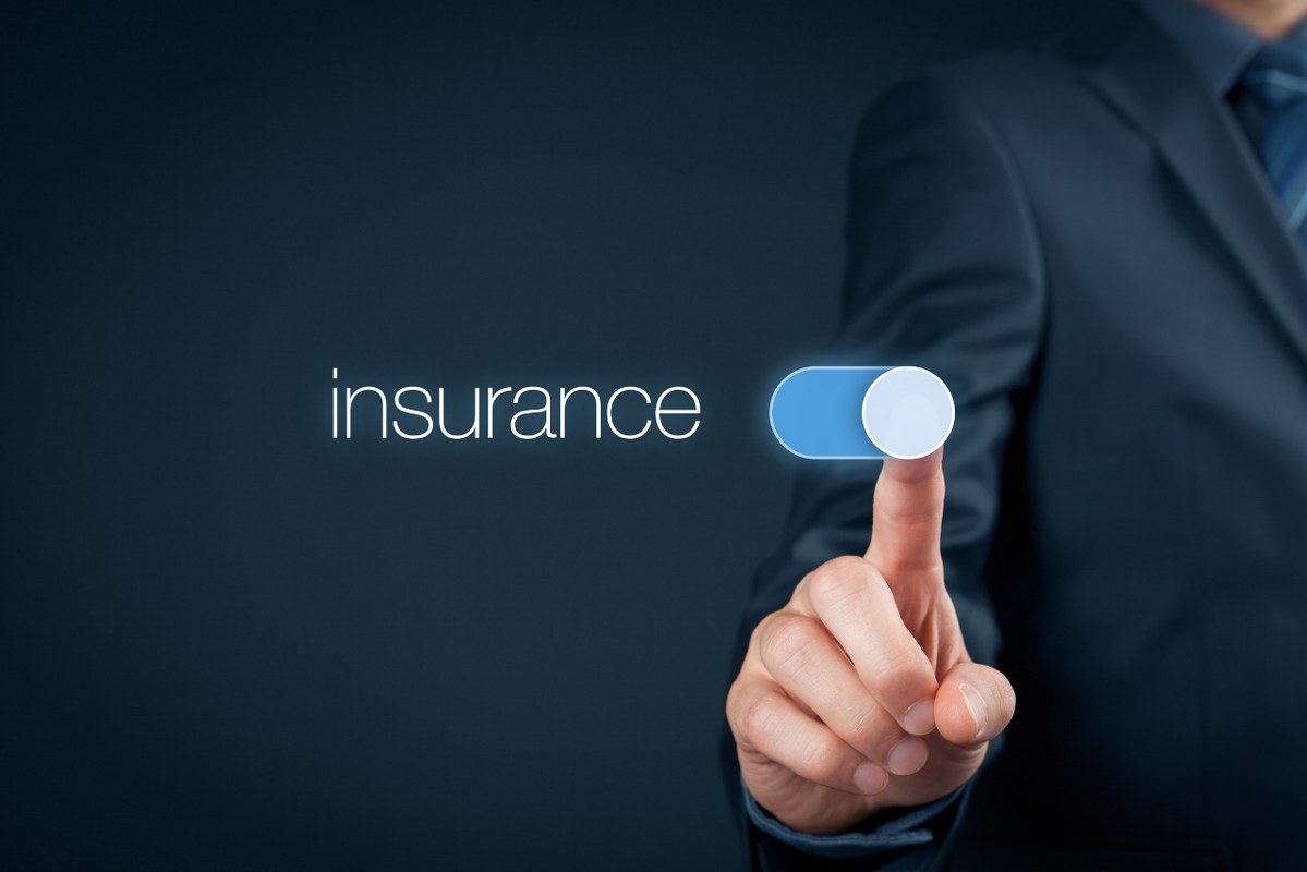 Businessman's hand switches to insurance mode.